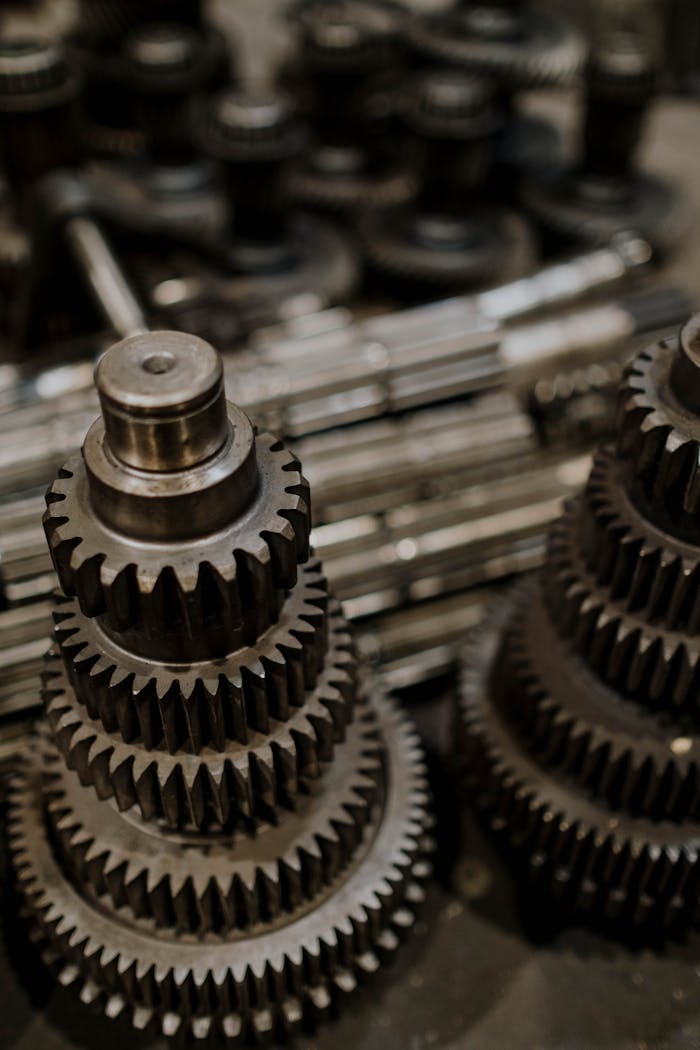 Services-01 Close-up view of stacked metal gears in a workshop, highlighting precision engineering.